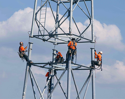 group of construction workers building a tower