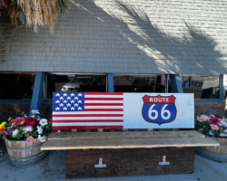 A bench painted with an American flag and the Route 66 symbol is pictured outside of the Ludlow cafe.