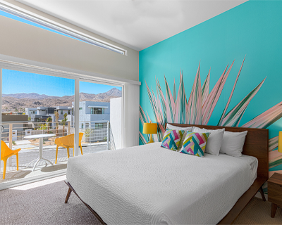 Brightly decorated room with mountain view at The Paloma Hotel.