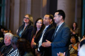 A group of attendees standing and applauding at the Clearinghouse CDFI 2024 Annual Shareholders Meeting.