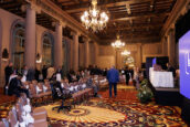 A spacious conference room set up for the Clearinghouse CDFI 2024 Annual Shareholders Meeting, with attendees in the background.