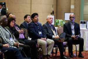 A row of seated individuals, attentively listening to a presentation. They are a diverse group of men and women, focused on something off-camera at the Clearinghouse CDFI 2024 annual shareholders meeting.