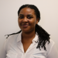 Shannon Lawrence, B BOLD(ER) intern at Clearinghouse CDFI, standing with a professional demeanor in the office