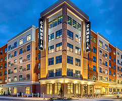 Cropped front view of the Cambria Rock Hill Hotel with illuminated signage and evening lighting