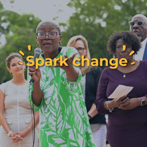 Community leader passionately speaking at the Chicon groundbreaking in Austin, Texas, highlighting the phrase "Spark Change."