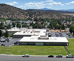 Aerial perspective of Fairchild Medical Center facility, parking area, and surrounding community in Yreka, CA