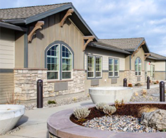 Close-up view of WindSong at Southridge Memory Care building featuring stone accents and detailed architecture