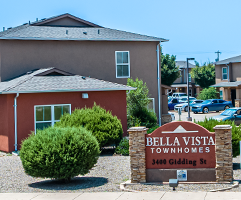 Bella Vista Townhomes entrance sign with residential buildings in the background