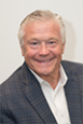 Douglas Bystry headshot, smiling man in suit jacket against plain background