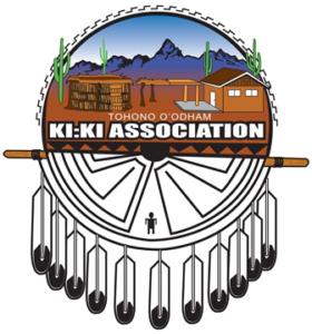 Logo of the Tohono O’odham Ki:Ki Association featuring desert imagery, traditional structures, mountains, and stylized feather elements.