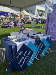 Clearinghouse CDFI booth setup at the 2025 Walk to End Alzheimer’s, featuring event signage, giveaways, and a Message of Hope display.