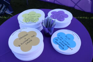 Stacks of colorful flower-shaped cards at Clearinghouse CDFI’s Message of Hope booth, each color representing a different connection to Alzheimer’s or dementia.
