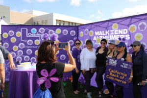 Participants at the 2025 Walk to End Alzheimer’s stop by the Clearinghouse CDFI Message of Hope booth to write personal tributes and take photos in support of the cause.