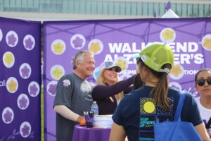 Clearinghouse CDFI President, CEO, and Founder Douglas Bystry and attendees at the Message of Hope booth during the 2025 Walk to End Alzheimer’s.