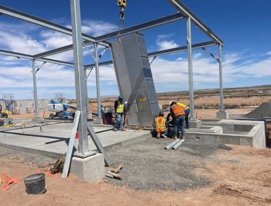 Construction crew working on metal building exterior at Chinle Wastewater Treatment Plant in Chinle, AZ, a Clearinghouse CDFI NMTC borrower project