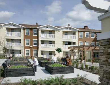 Exterior setting of Tyrol Plaza affordable senior living apartments and raised garden beds in Anaheim, CA, a Clearinghouse CDFI loan project