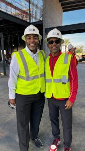 Two men in construction vests standing amidst Clearinghouse CDFI NMTC project West Las Vegas Library