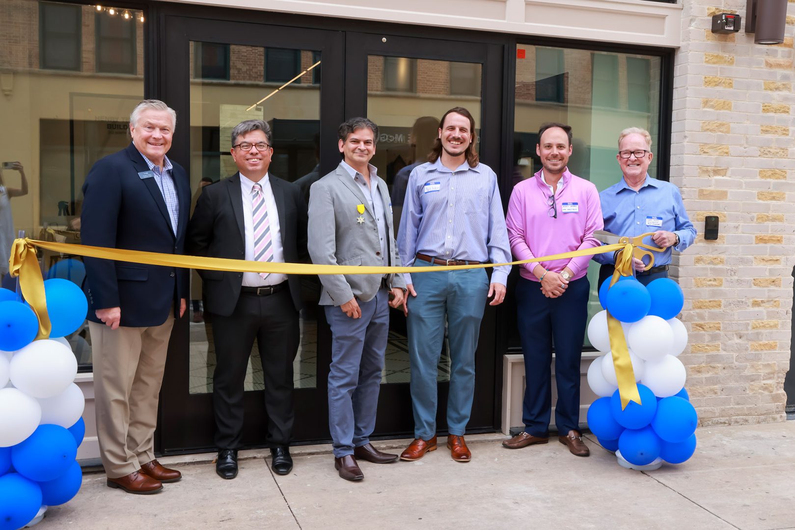 Clearinghouse CDFI staff members, including President, Founder, and CEO Doug Bystry, at ribbon-cutting ceremony for Opportunity Zone project