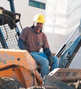 Developer sitting on excavator in Opportunity Zone project, representing Clearinghouse CDFI's Opportunity Zone offerings