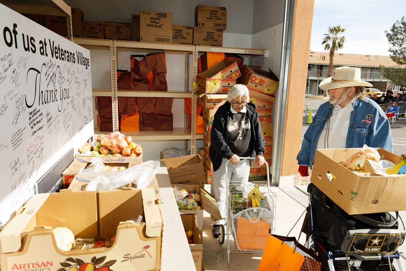 Man and woman shopping for groceries at event held by Veterans Village, a Clearinghouse CDFI loan project providing affordable housing for U.S. veterans