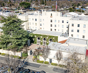 Aerial view of the historic Hotel Woodland in Woodland, CA, a mixed-use building with affordable SRO housing and ground-floor commercial space.